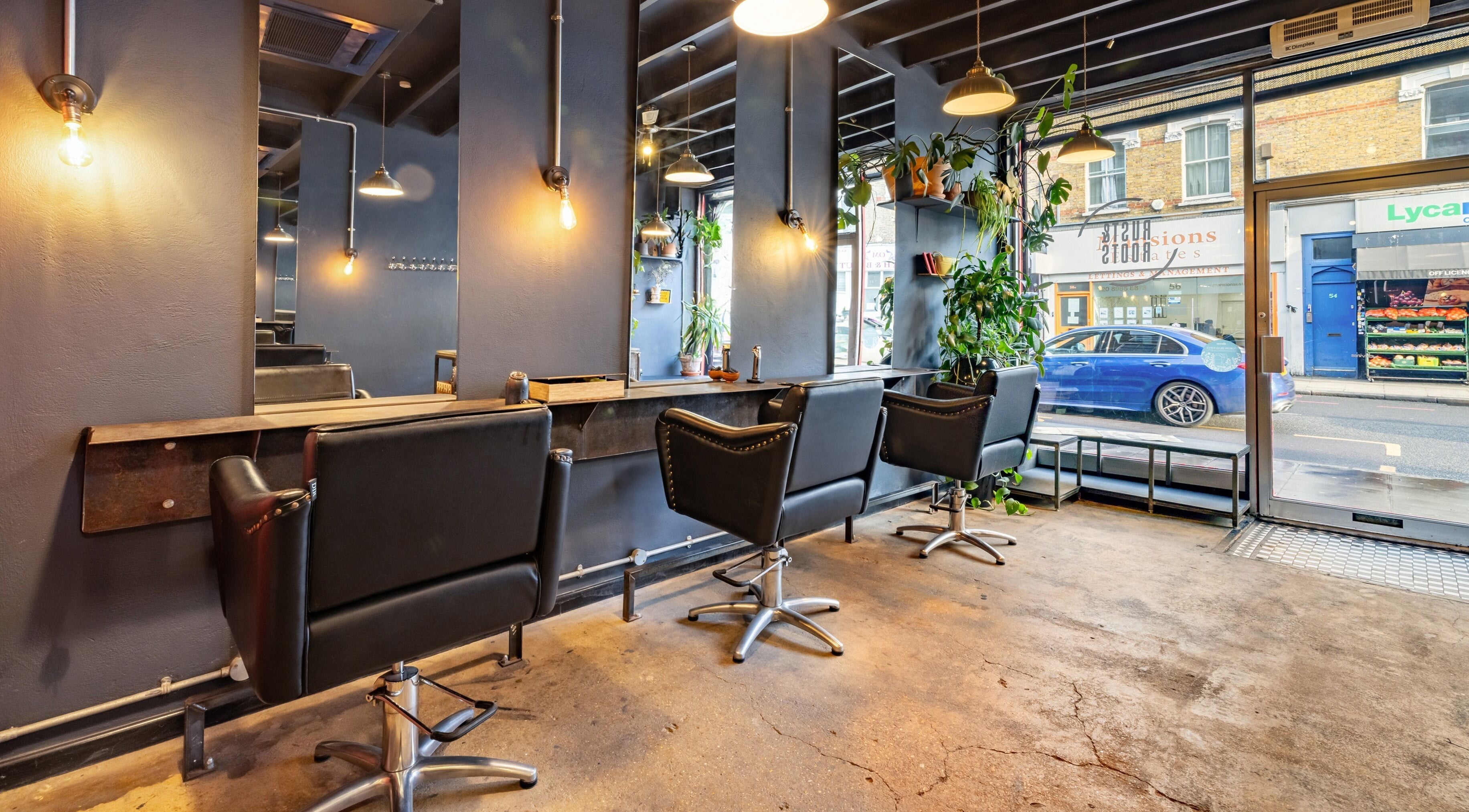 Chic interior of Rust & Roots salon in London, England, GB, featuring stylish chairs and modern decor.