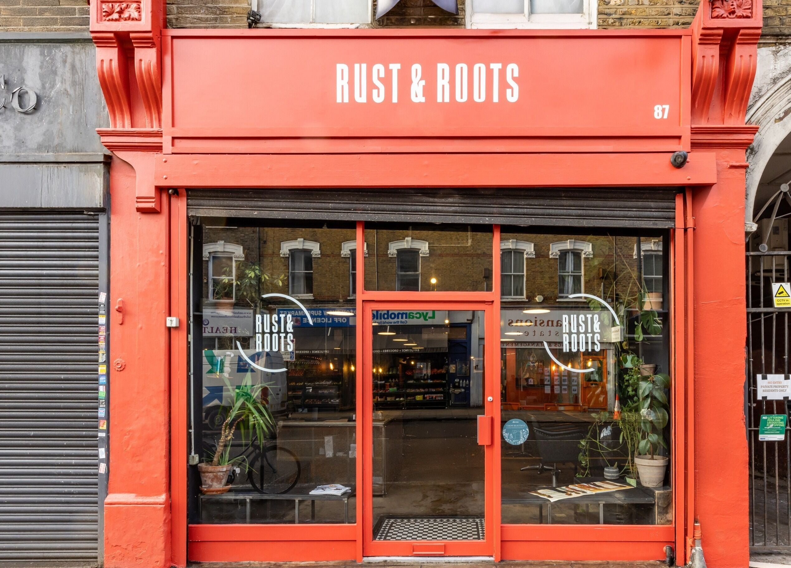 Rust & Roots entrance with red signage in London, England, GB.