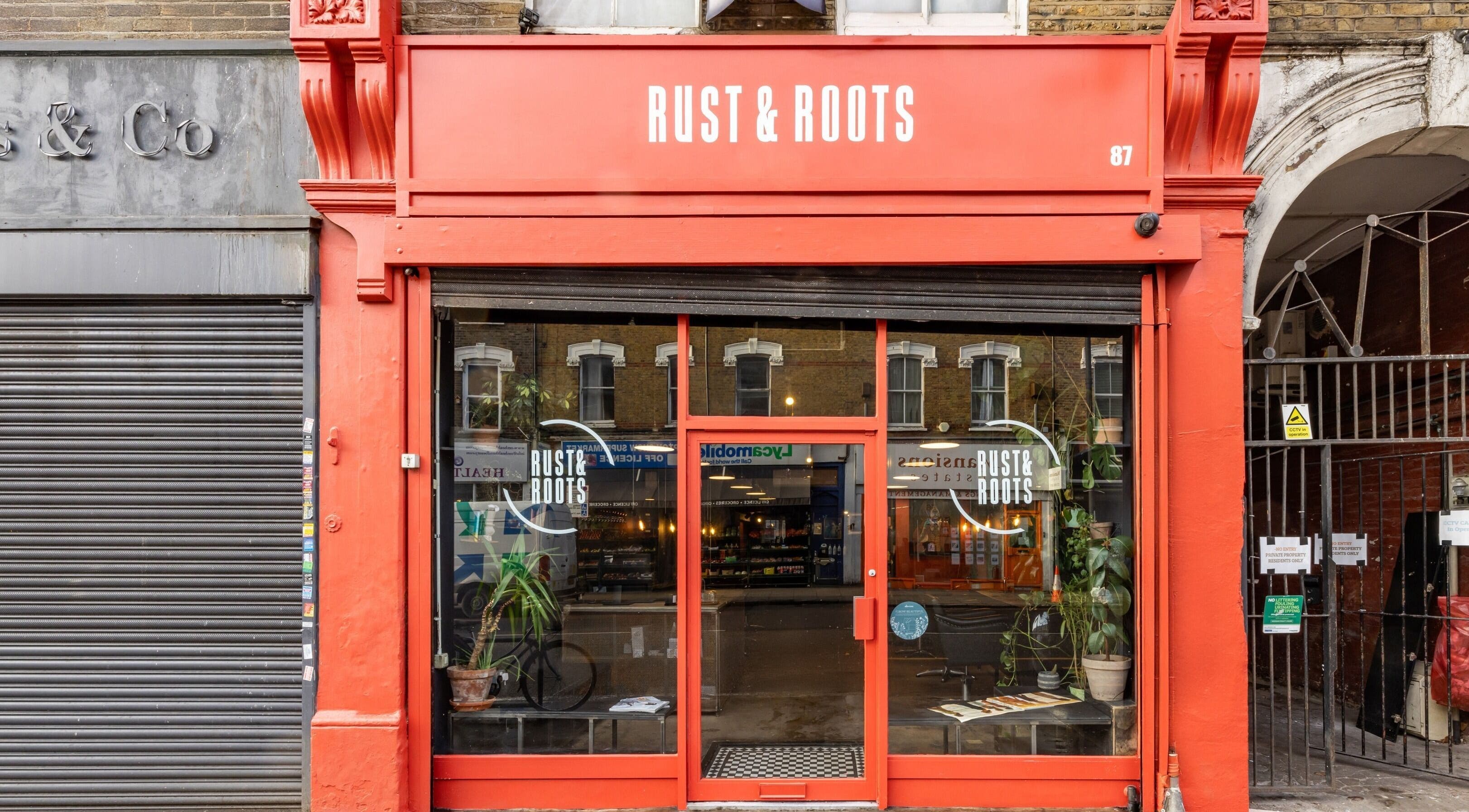 Rust & Roots entrance with red signage in London, England, GB.
