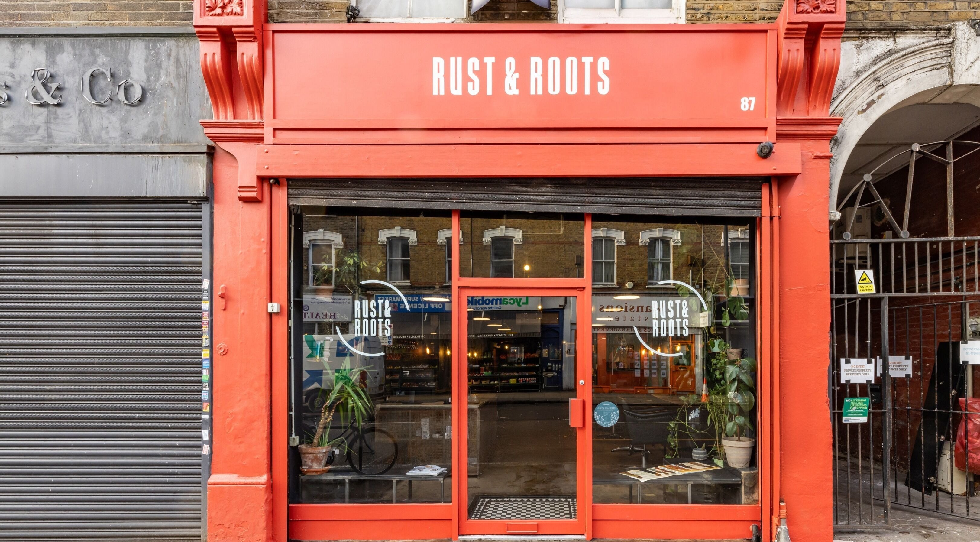 Rust & Roots entrance with red signage in London, England, GB.