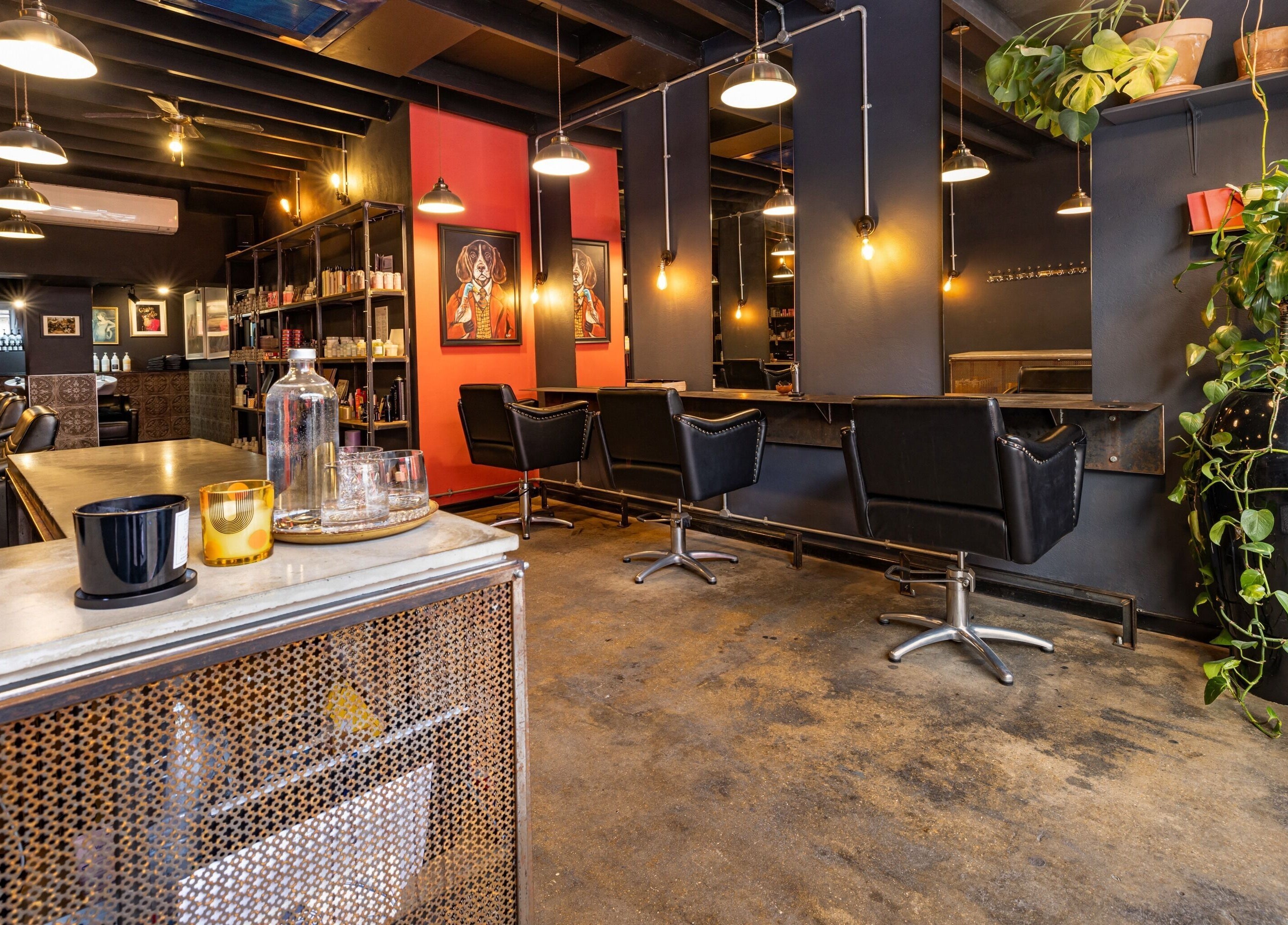 Chic interior of Rust & Roots, London, England, GB, showcasing salon chairs and vibrant decor elements.