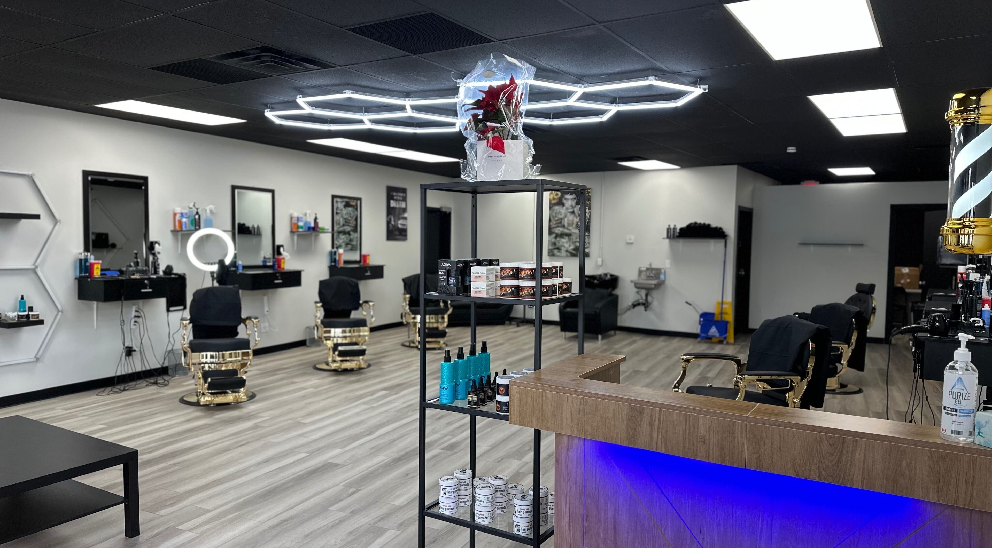 Modern interior of Queensland barbers in Calgary, Alberta, CA with sleek chairs and styling products.