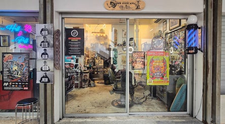 Entrance of Big Bad Wolf Barbershop in Singapore, SG showcasing retro decor and vibrant posters.