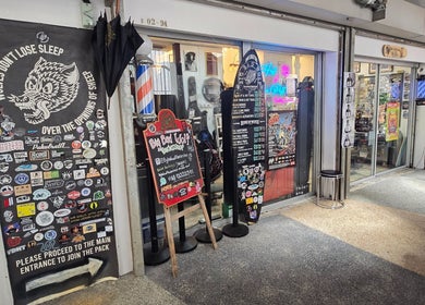 Entrance of Big Bad Wolf Barbershop with signage and decal art in Singapore, Singapore, SG.