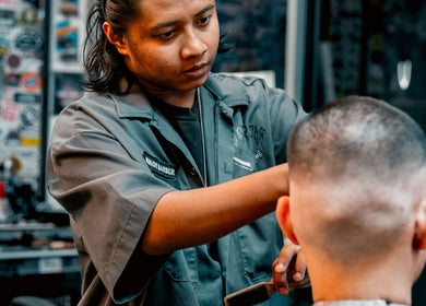 Barber styling a client's hair at Big Bad Wolf Barbershop in Singapore, Singapore, SG.
