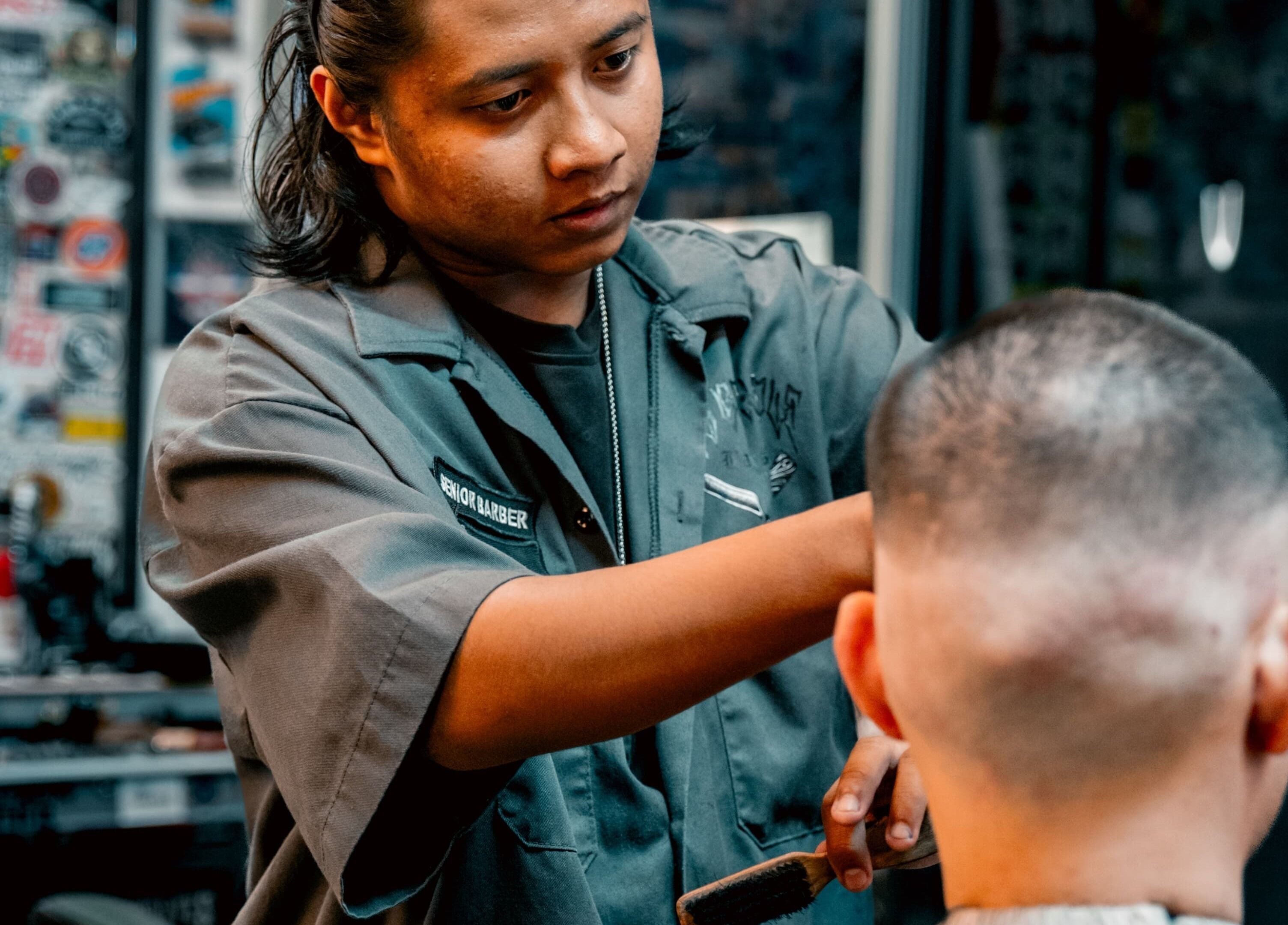 Barber styling a client's hair at Big Bad Wolf Barbershop in Singapore, Singapore, SG.