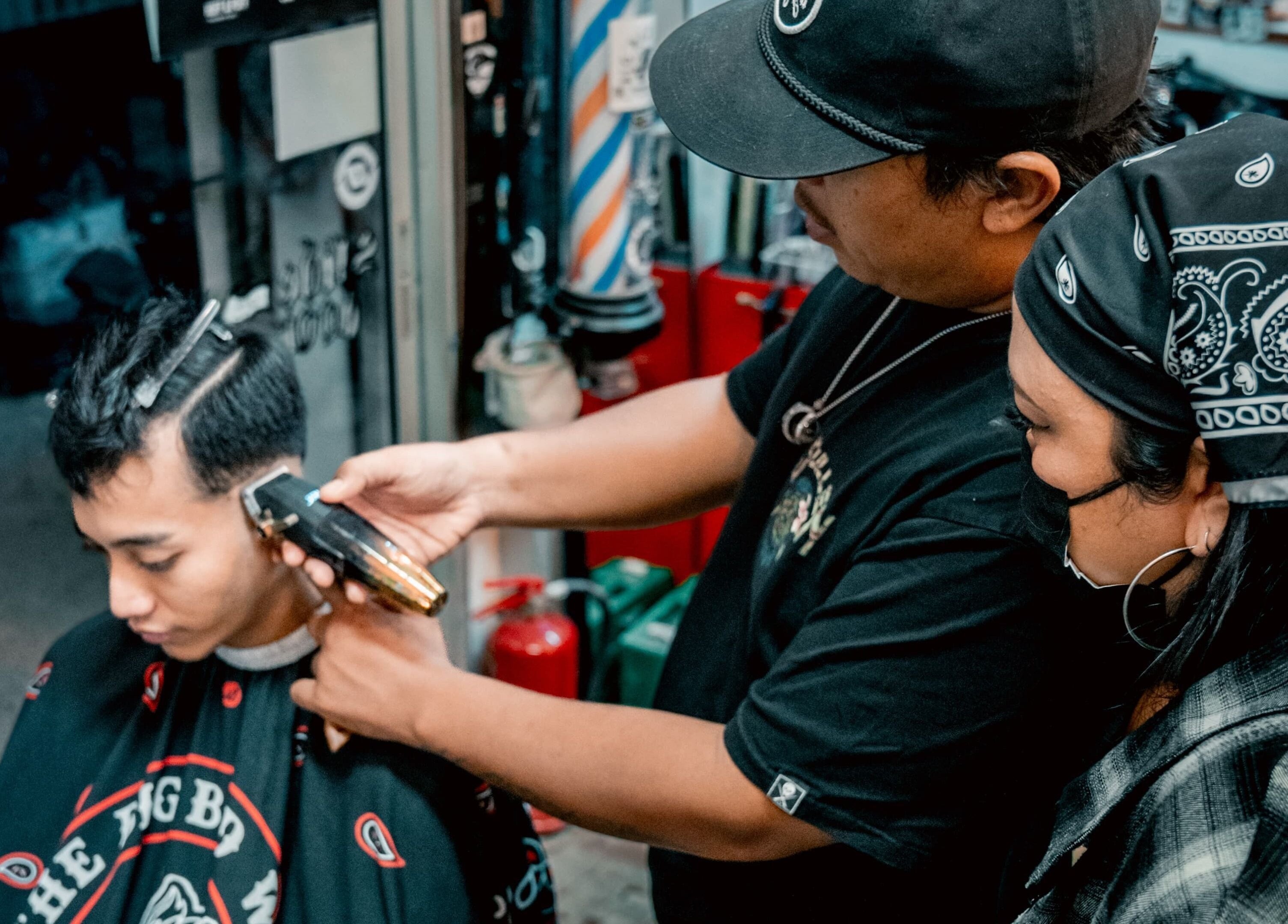 Barber expertly trims hair at Big Bad Wolf Barbershop, Singapore, SG, ensuring a stylish finish.