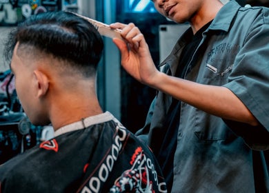 Barber styling hair at Big Bad Wolf Barbershop, Singapore, SG with precision and care.