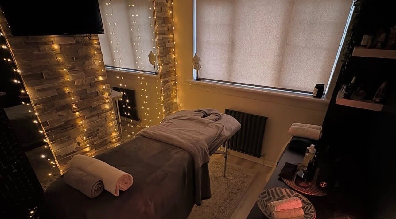 Cozy massage room at 1720 Massage Studio, Paisley, Scotland, GB, with serene lighting and a massage bed.
