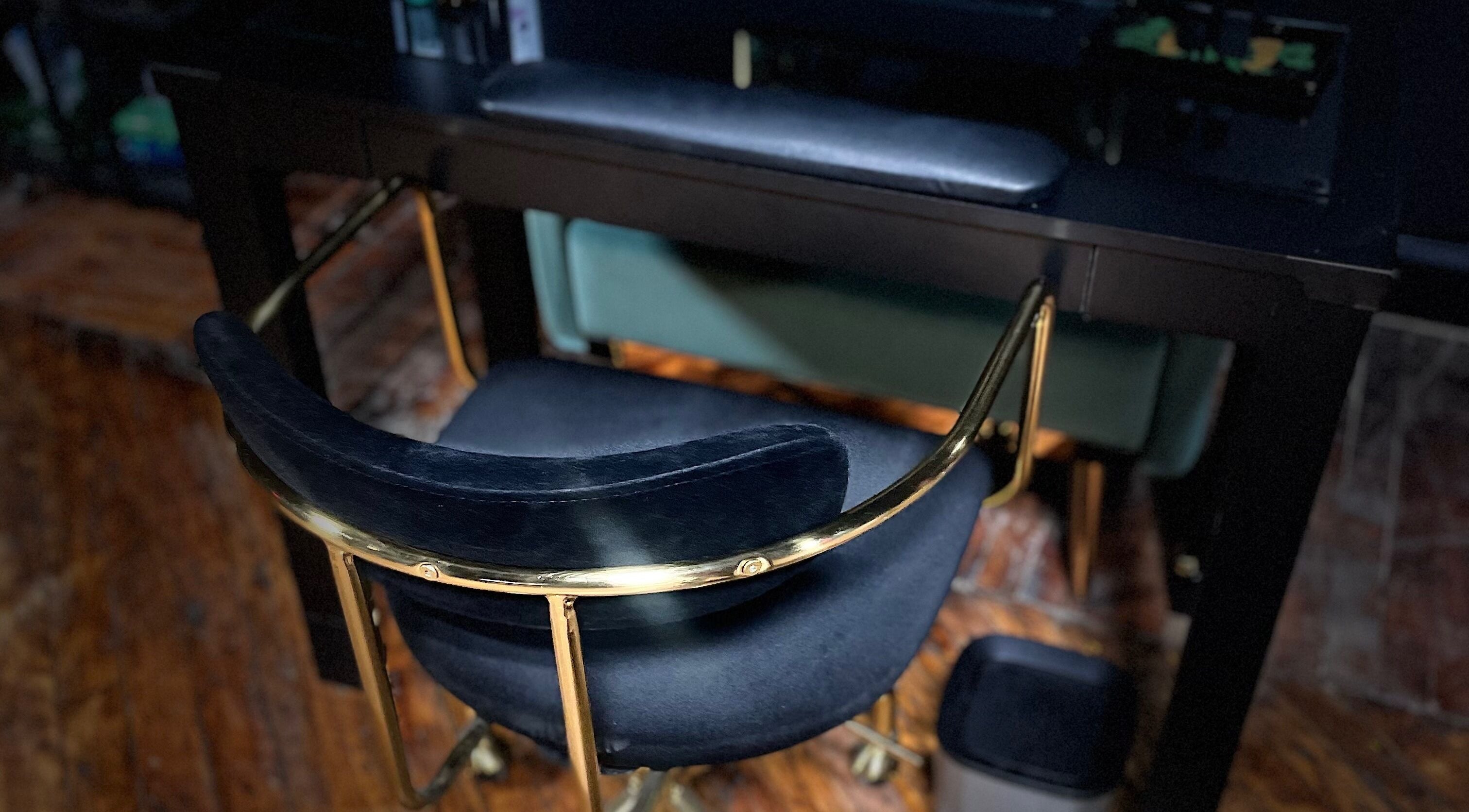 Elegant nail station at Nails of Hercules in Boston, Massachusetts, featuring a plush chair and golden accents.