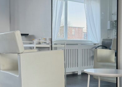 Elegant interior of Gemini Studio in Northallerton, England, GB with chic chair and mirror by the window.