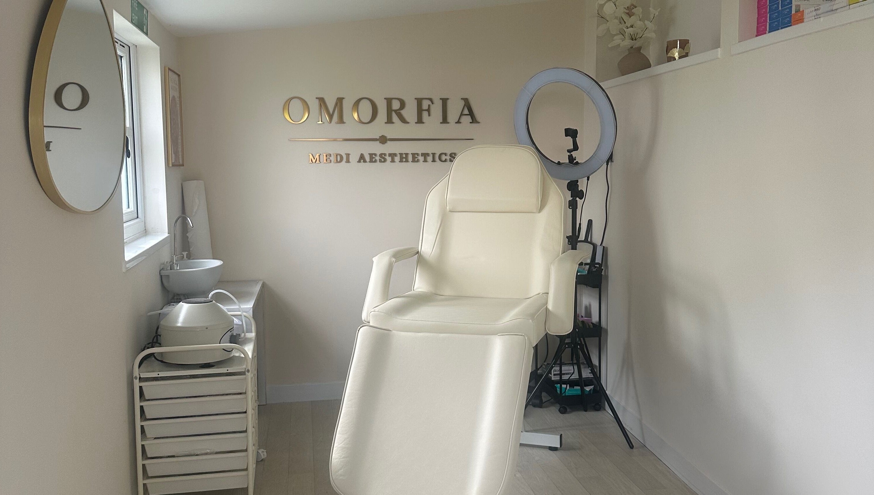 Serene treatment chair at OMORFIA Medi Aesthetics Tiverton, Bolham, England, GB with sleek interior.