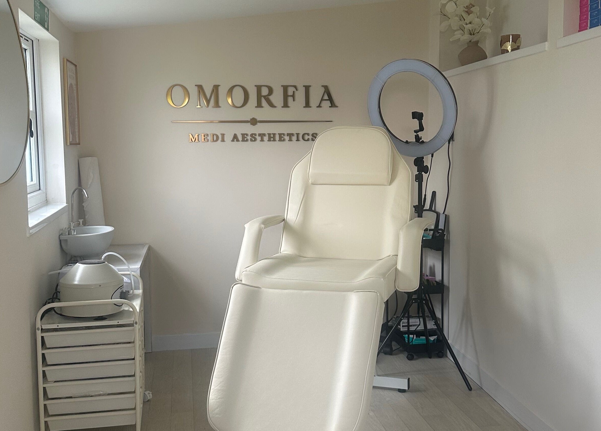 Serene treatment chair at OMORFIA Medi Aesthetics Tiverton, Bolham, England, GB with sleek interior.