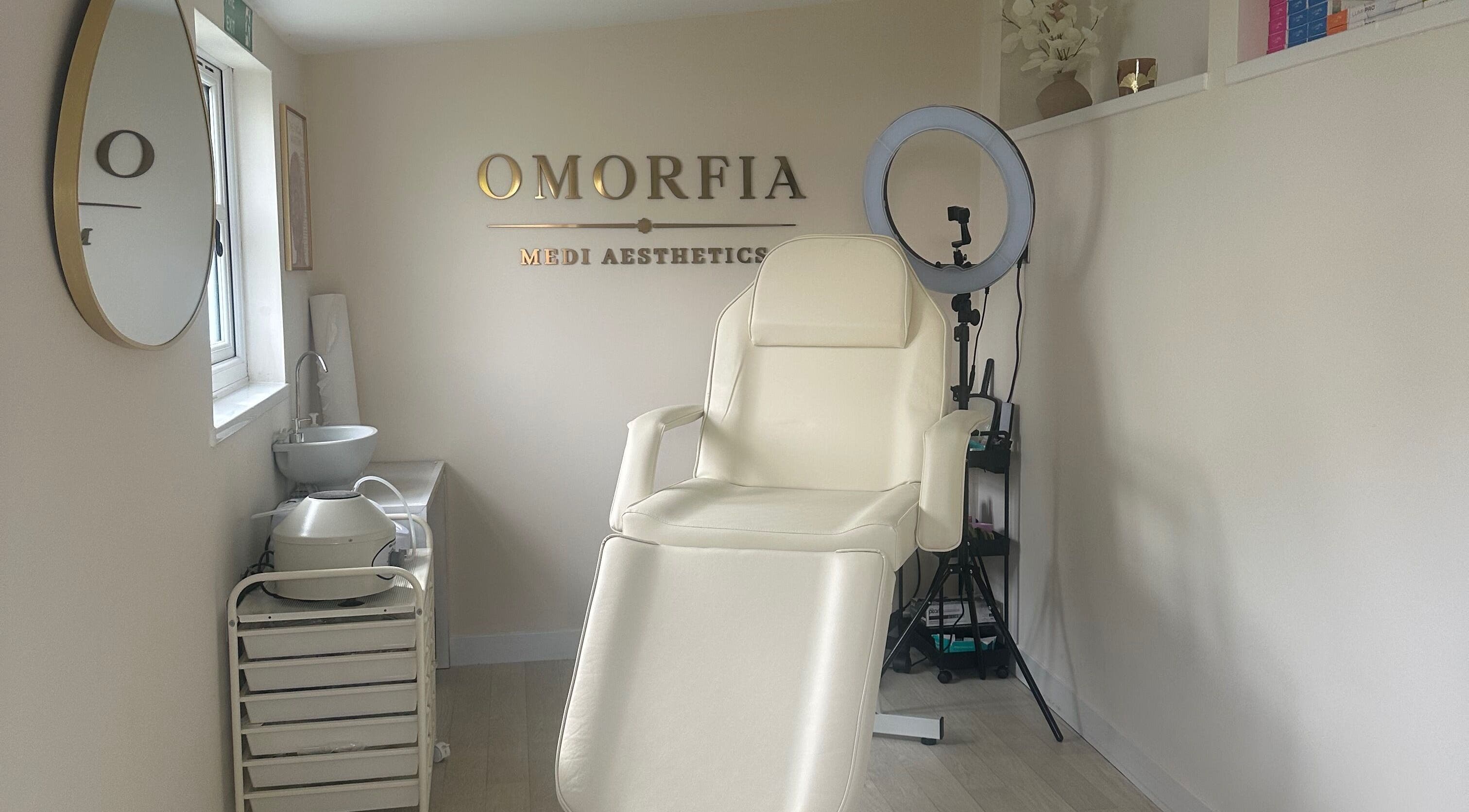 Serene treatment chair at OMORFIA Medi Aesthetics Tiverton, Bolham, England, GB with sleek interior.