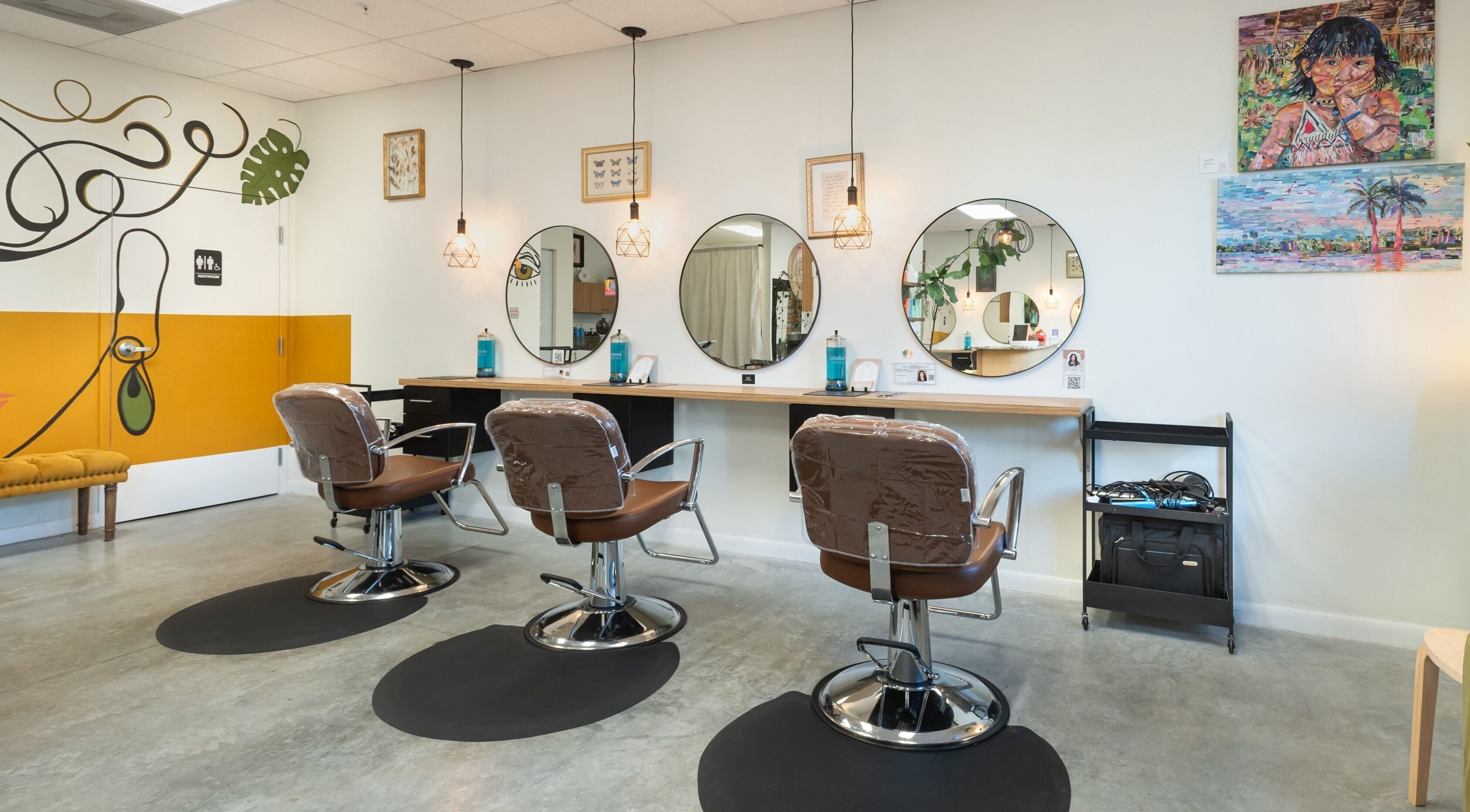 Modern design at Kairos Hair Salon, Miami Lakes, Florida, US with stylish chairs and mirrors.