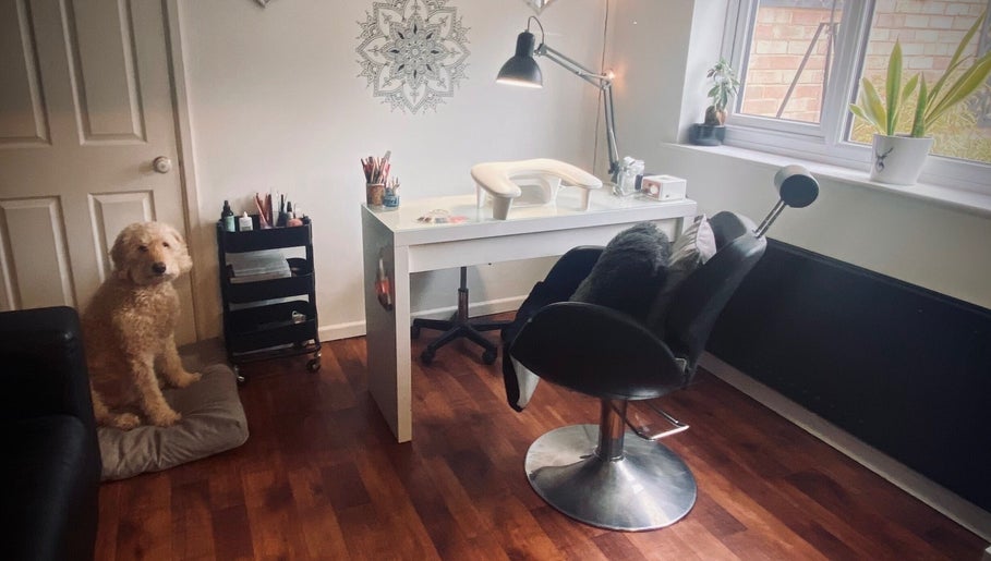 Nikki Halcoop Beauty salon in Donnington, England with a stylish desk, chair, and a friendly dog beside it.