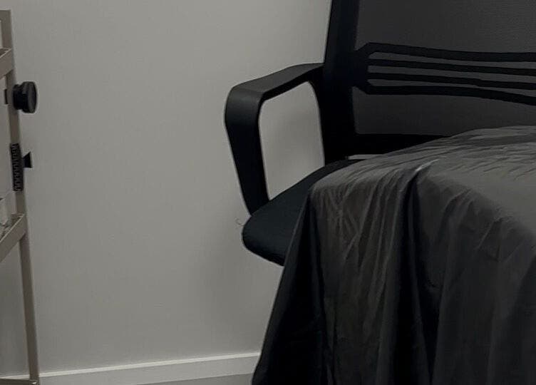 Treatment room at Obsidian Lounge, Dublin, County Dublin, IE, featuring comfortable chair and organized supplies.