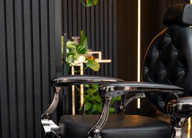 Elegant barber chair at Omen Collective in Fortitude Valley, Queensland, AU, highlighting modern luxury.