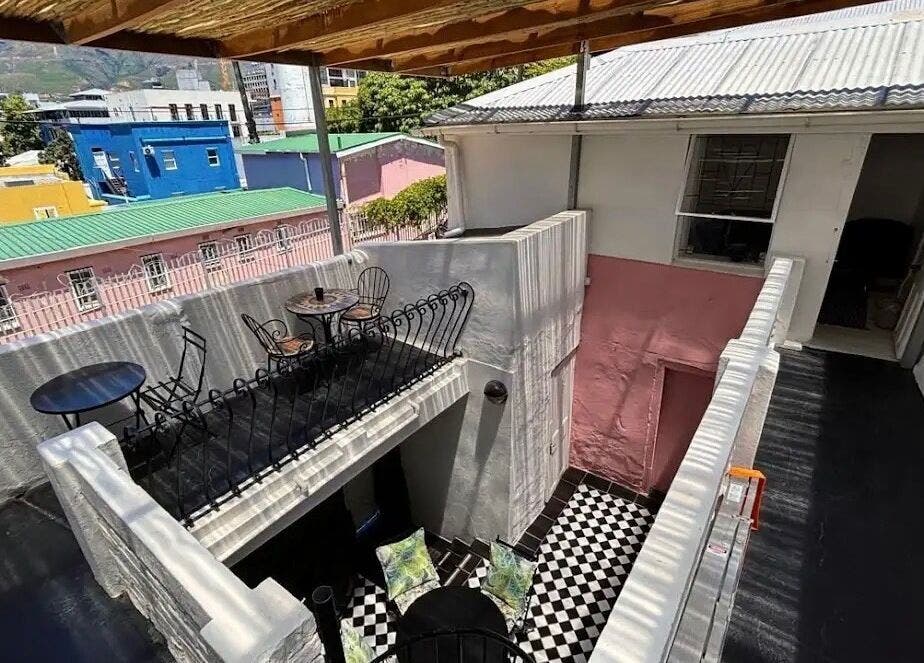 Charming rooftop view from BrowsbyFadia, Cape Town, Western Cape, ZA. Vibrant colors with elegant seating.