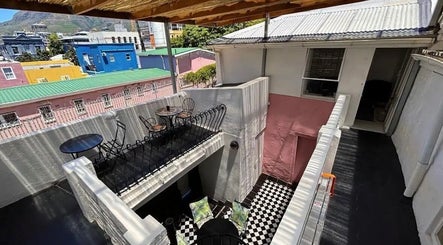Charming rooftop view from BrowsbyFadia, Cape Town, Western Cape, ZA. Vibrant colors with elegant seating.