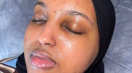 Close-up of a relaxed woman's face post-treatment at Muniira's Clinic, London, England, GB.