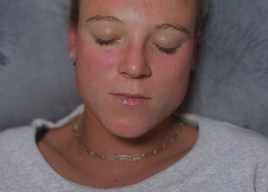 Relaxed person enjoying facial treatment at Muniira's Clinic, London, England, GB.