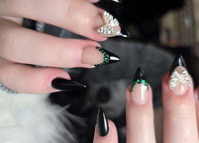 Stylish black nails with green stones and silver designs at T-Nails Glam Studio, Providence, Rhode Island, US.