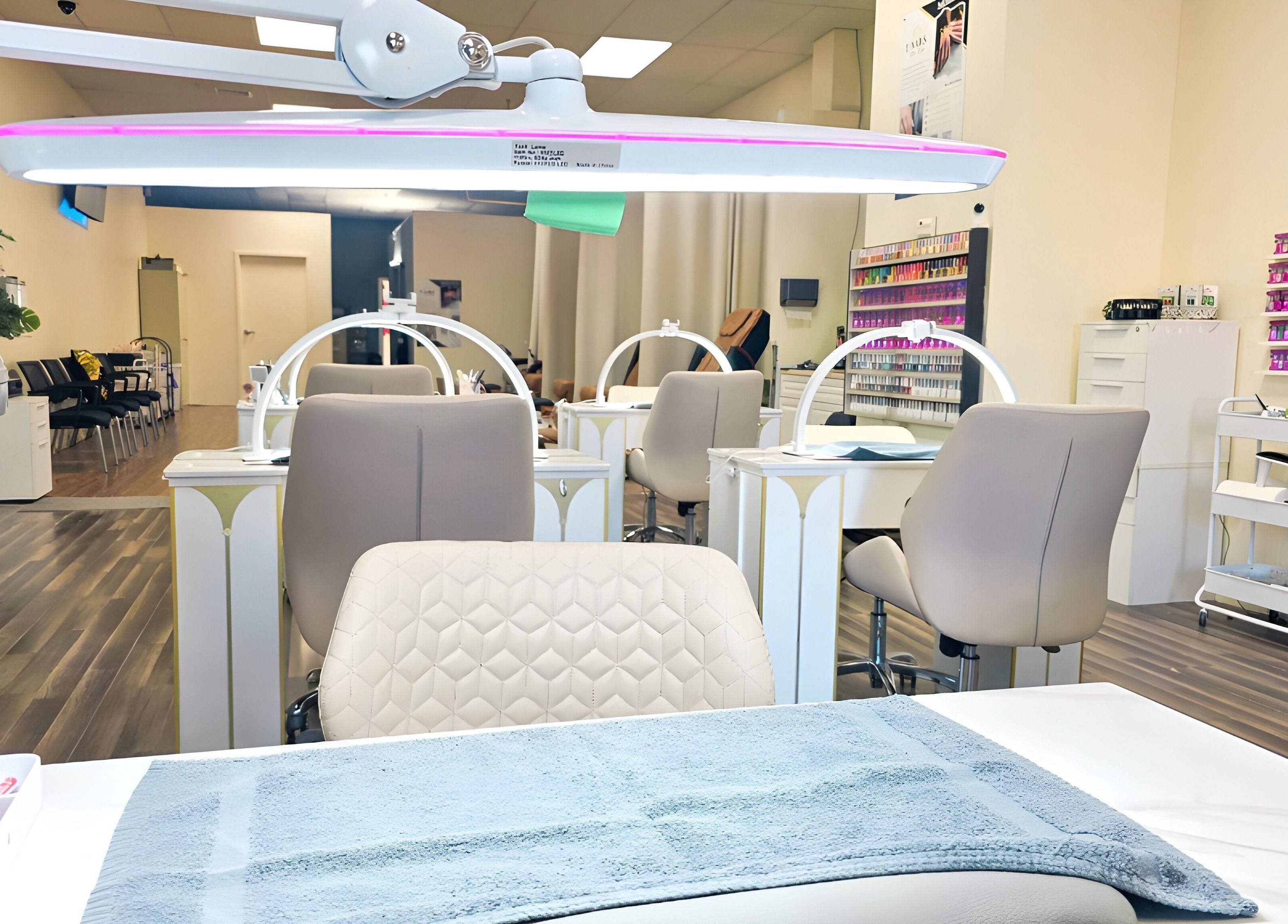 Bright, modern interior of T-Nails Glam Studio in Providence, Rhode Island, US, showcasing elegant nail stations.