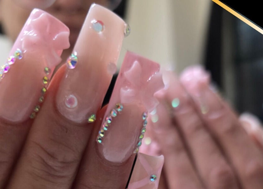 Elegant pink acrylic nails with rhinestones at T-Nails Glam Studio, Providence, Rhode Island, US.