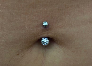 Close-up of a navel with a sparkling piercing at ILW Body Piercing, Glenfield, England, GB.