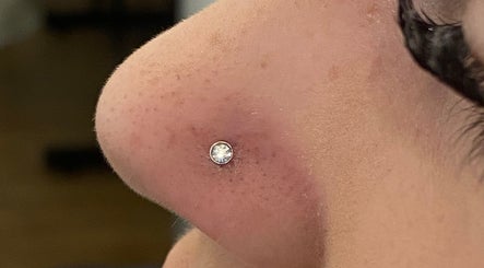 Close-up of nostril piercing with gem at ILW Body Piercing in Glenfield, England, GB.