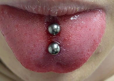 Close-up of double tongue piercing at ILW Body Piercing, Glenfield, England, GB.