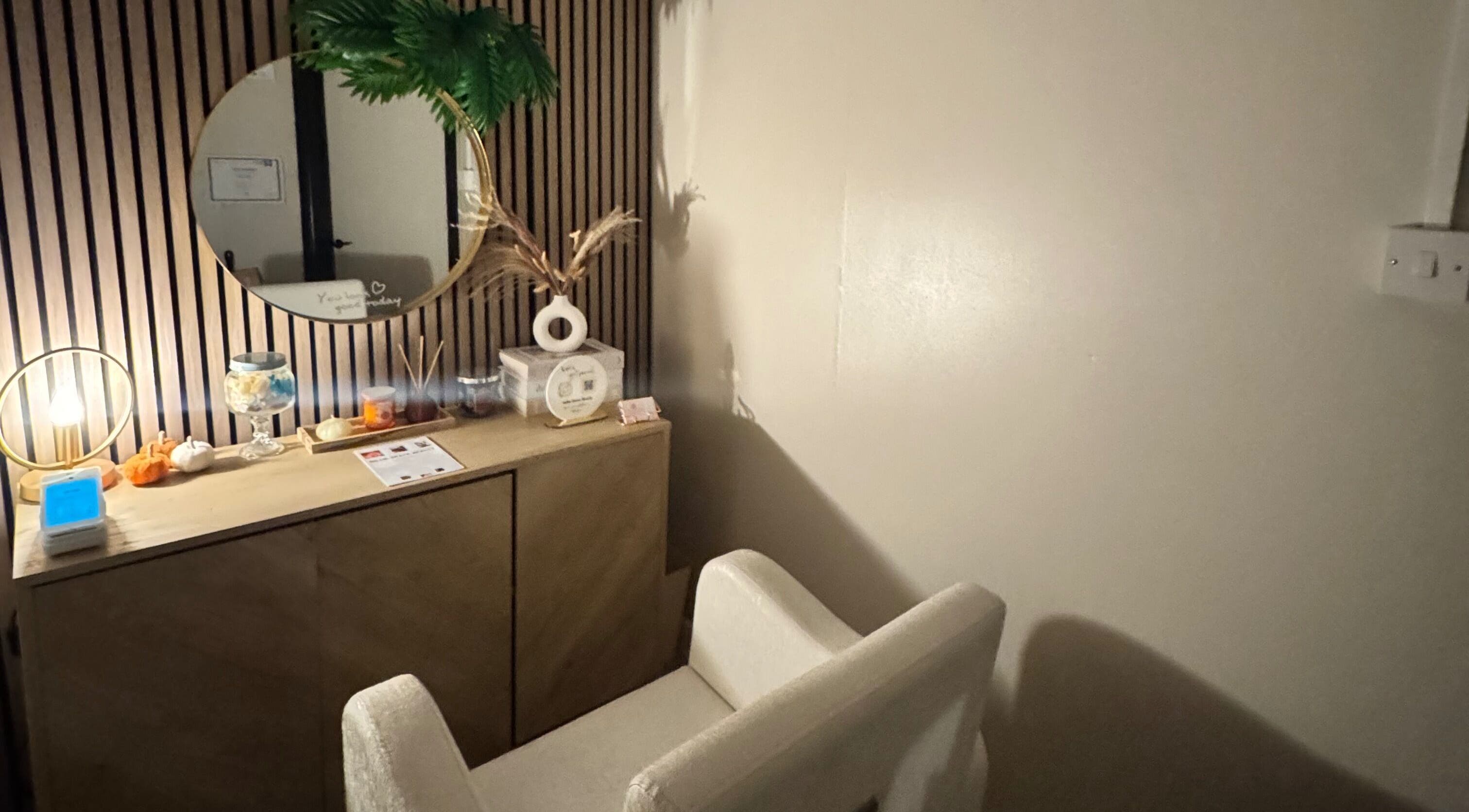Relaxing corner at Millie Grace Beauty in Barry, Wales with chair, mirror, and decor.