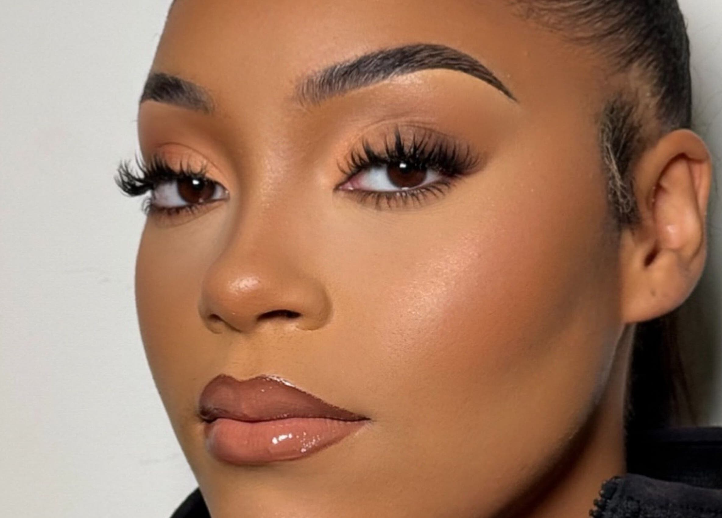 Elegant makeup at INTISAR, London, England, GB showcasing flawless skin and bold lashes.