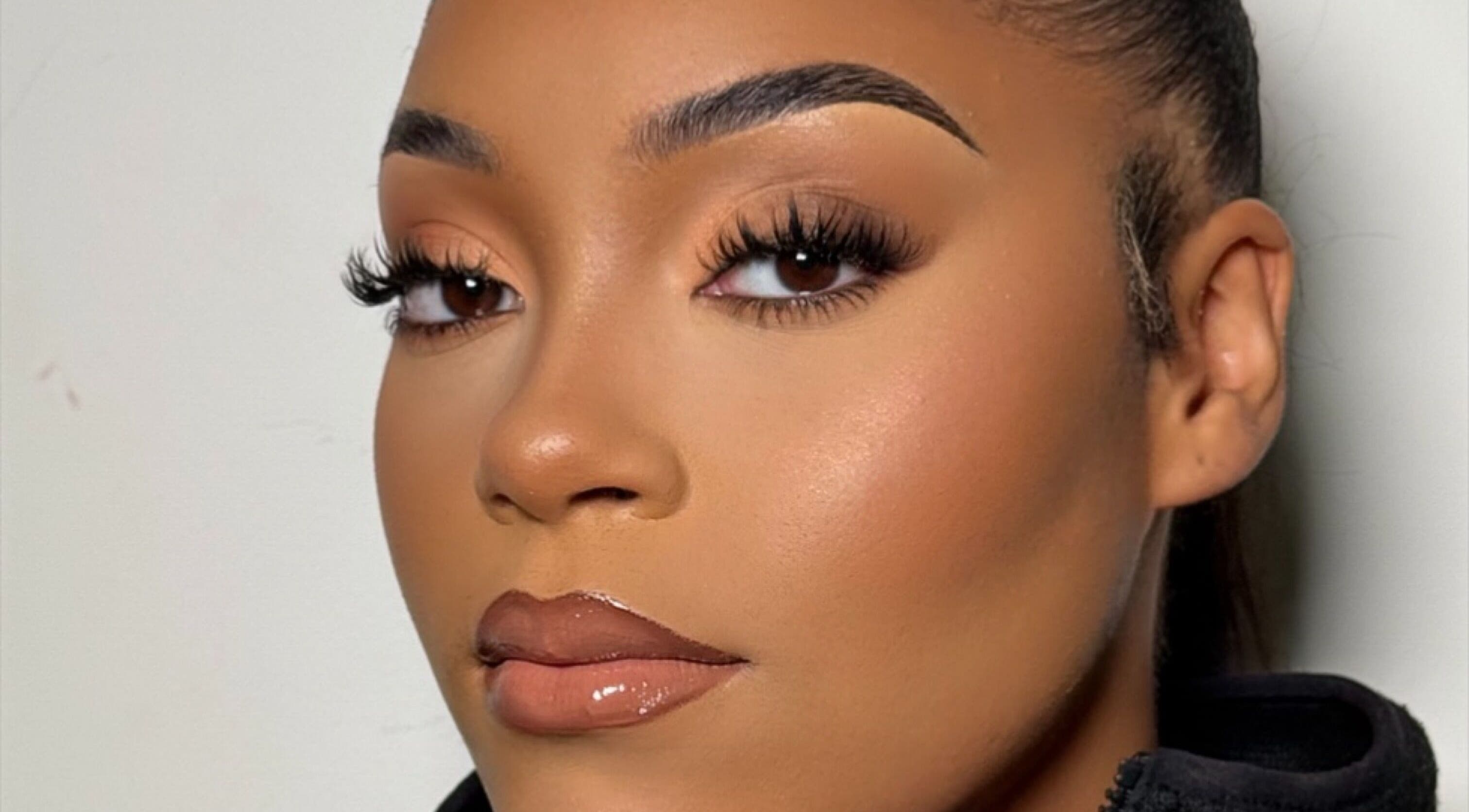 Stunning makeup artistry at INTISAR, London, England, GB showcases flawless lashes and glowing skin.