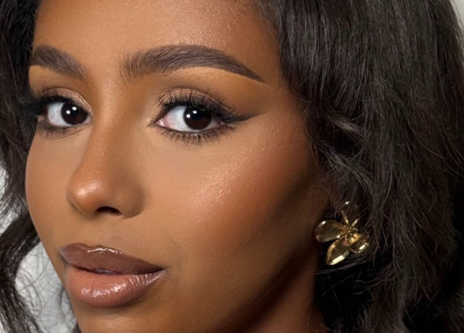 Close-up of elegant makeup at INTISAR, London, England, GB, showcasing flawless beauty with bold eye makeup.