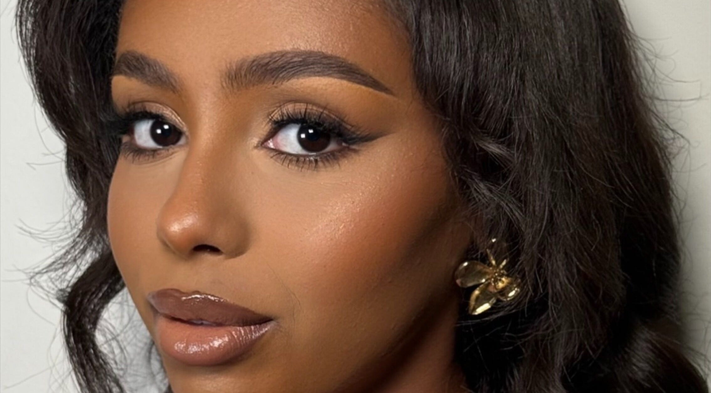 Close-up of elegant makeup at INTISAR, London, England, GB, showcasing flawless beauty with bold eye makeup.