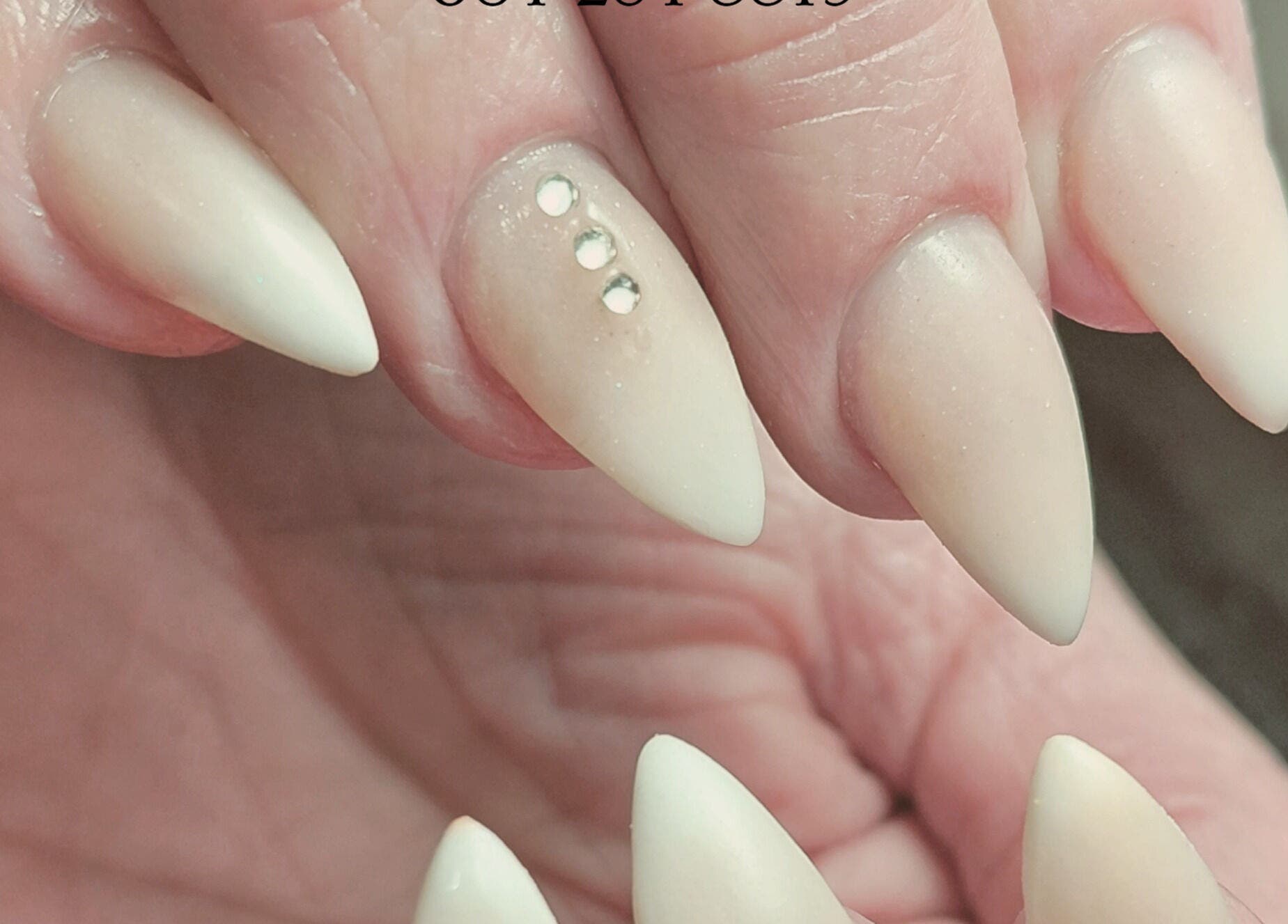 Elegant manicured nails with rhinestones at Damour Nails and Beauty, Kempton Park, Gauteng, ZA.