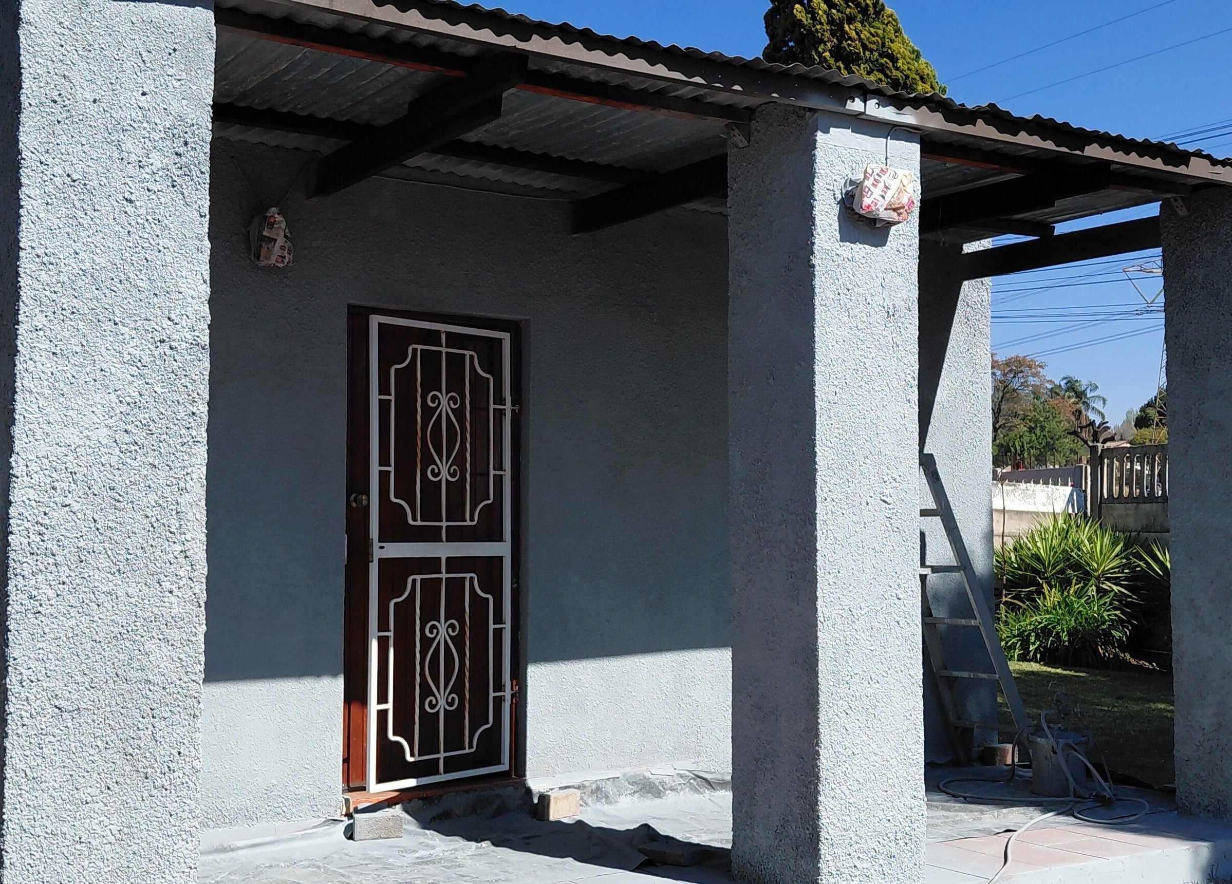 Cozy building entrance at Damour Nails and Beauty, Kempton Park, Gauteng, ZA, featuring a rustic door.