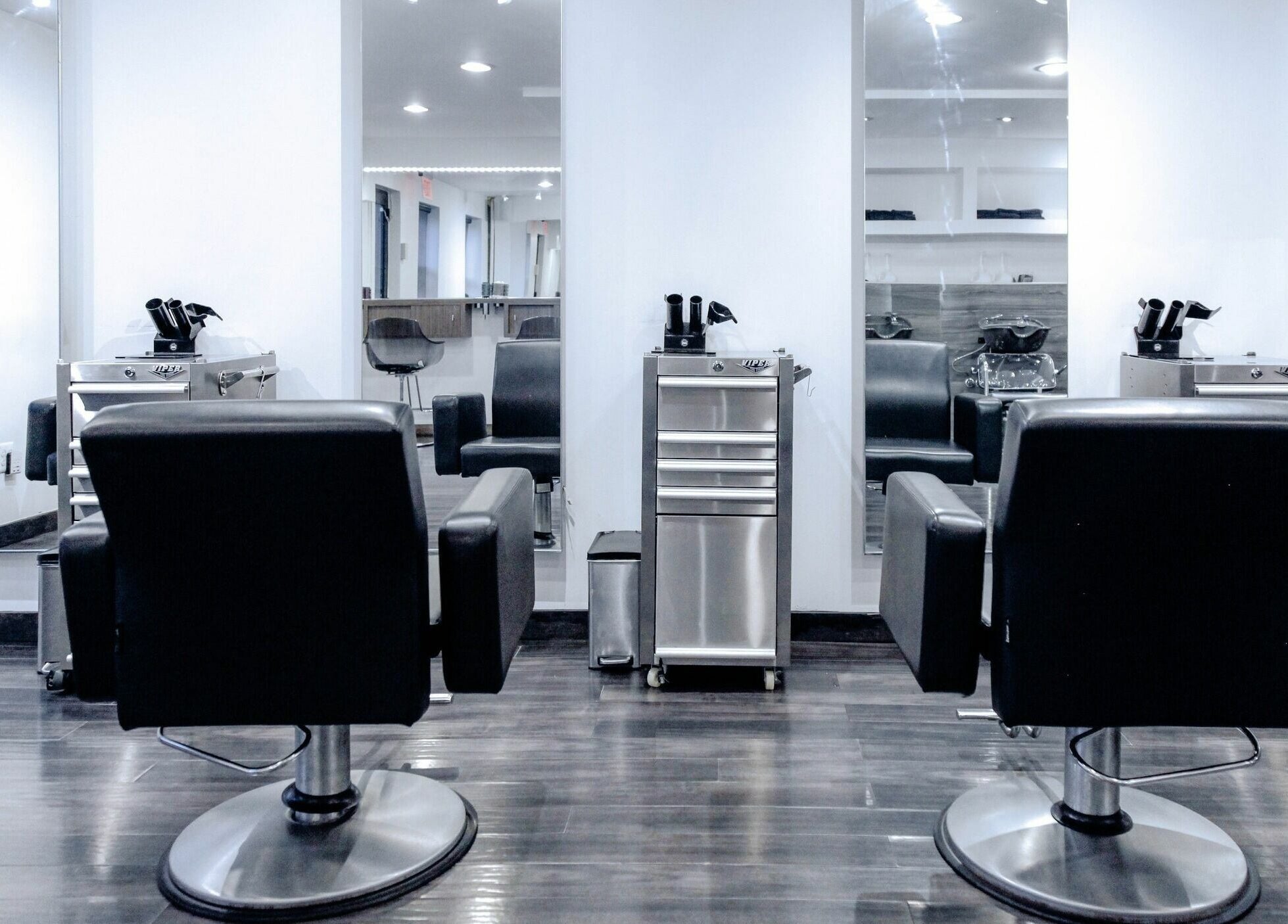 Modern salon chairs in H2 Salon Brooklyn, New York, New York, US with sleek design and bright mirrors.