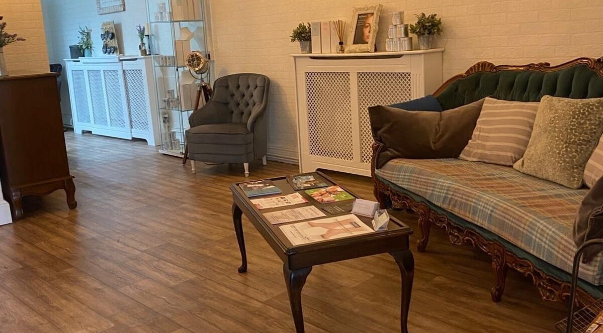 Stylish waiting area at Movement Clinics, Loughborough, England, GB with cozy seats and wooden table.