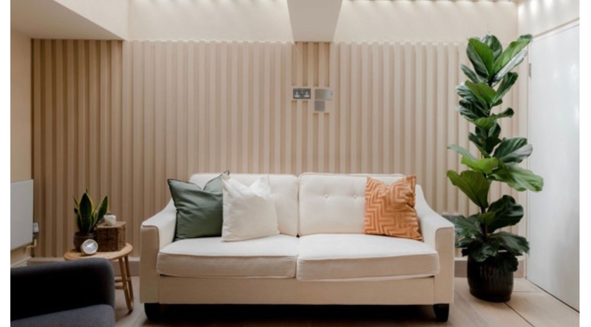 Relaxing lounge area at Movement Clinics London with a cozy sofa, plants, and calming decor. London, England, GB.