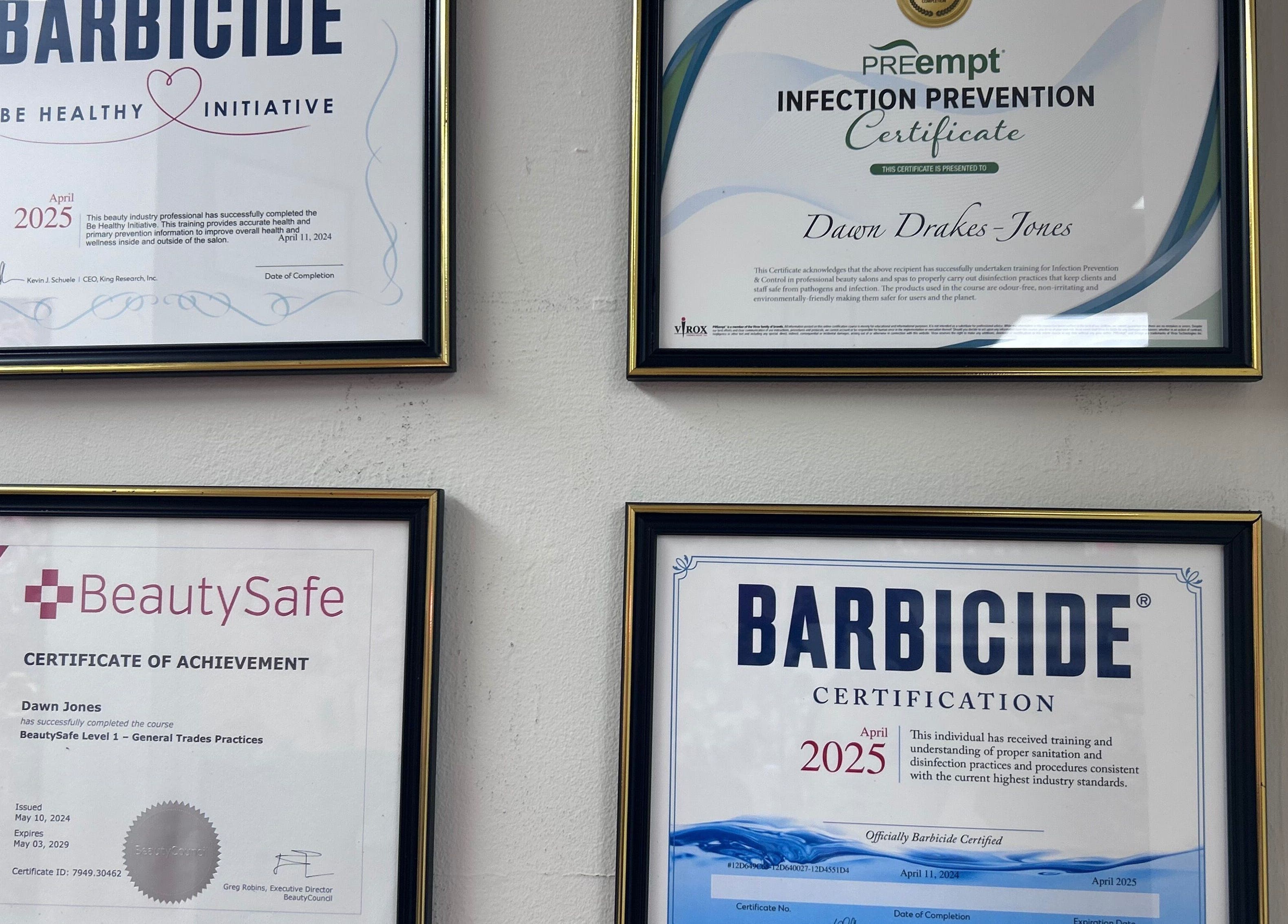 Certification wall at Beauty Girl Studios, Toronto, Ontario, CA showcasing professional qualifications.