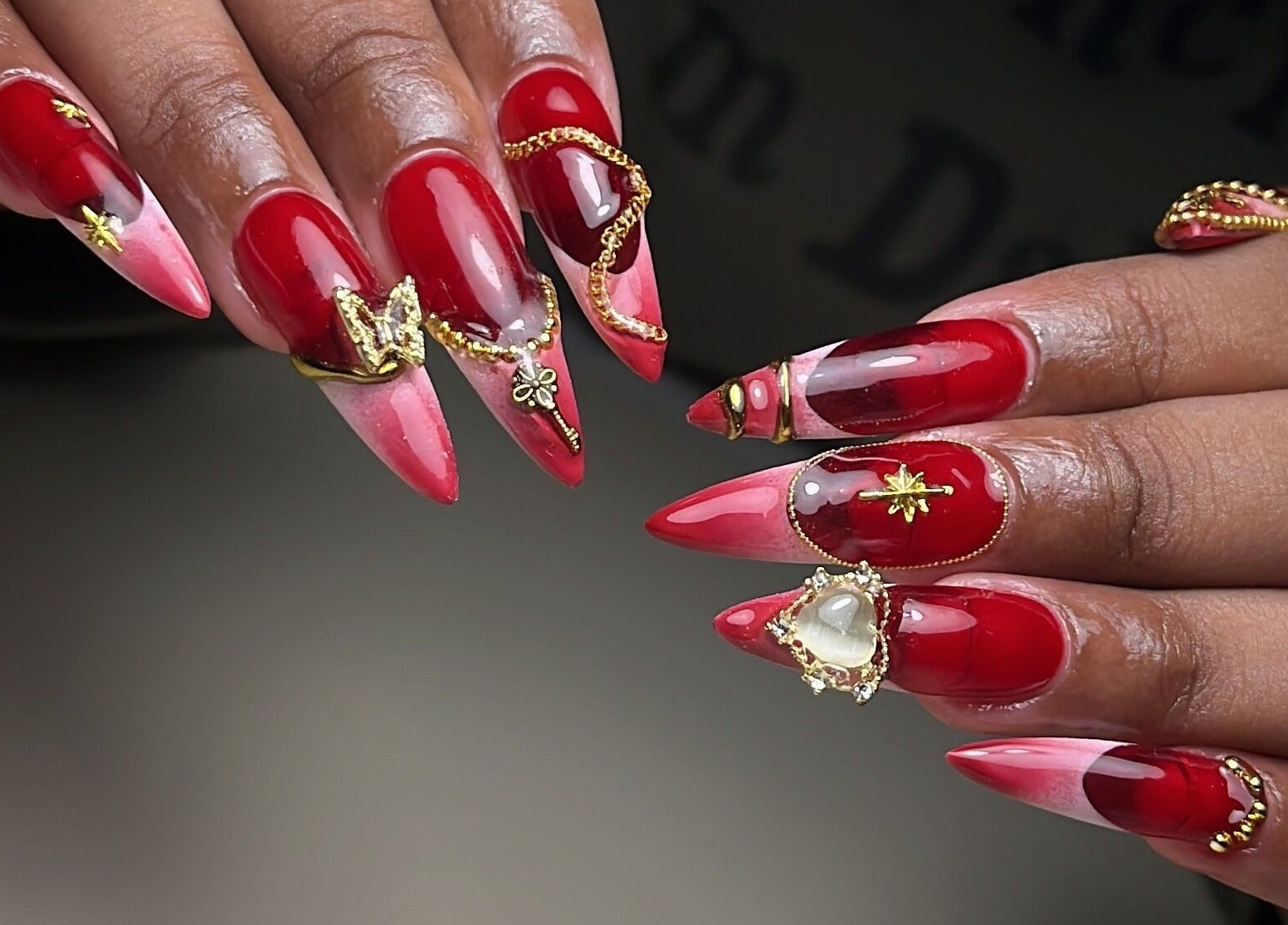 Intricate red nail art with gold accents at Aeonian Nails, Petaling Jaya, Selangor, MY.