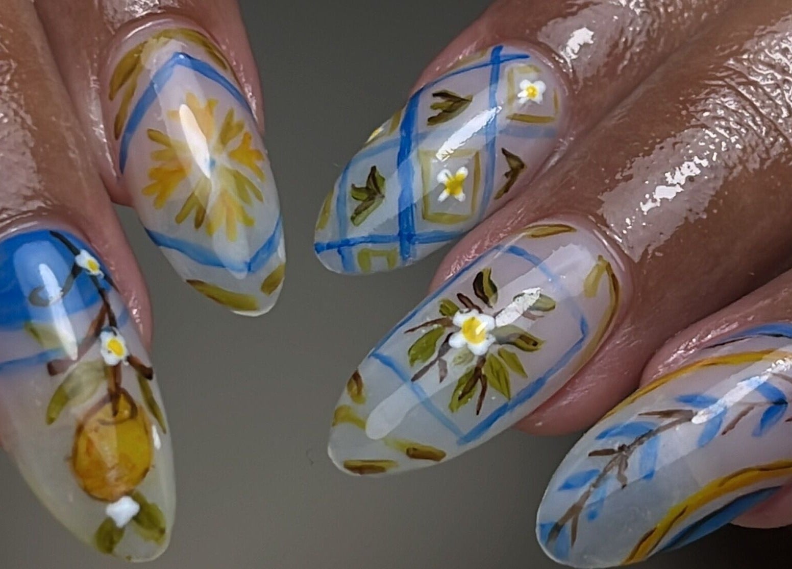 Intricate floral nail art at Aeonian Nails, Petaling Jaya, Selangor, MY. Vibrant blue and yellow designs.