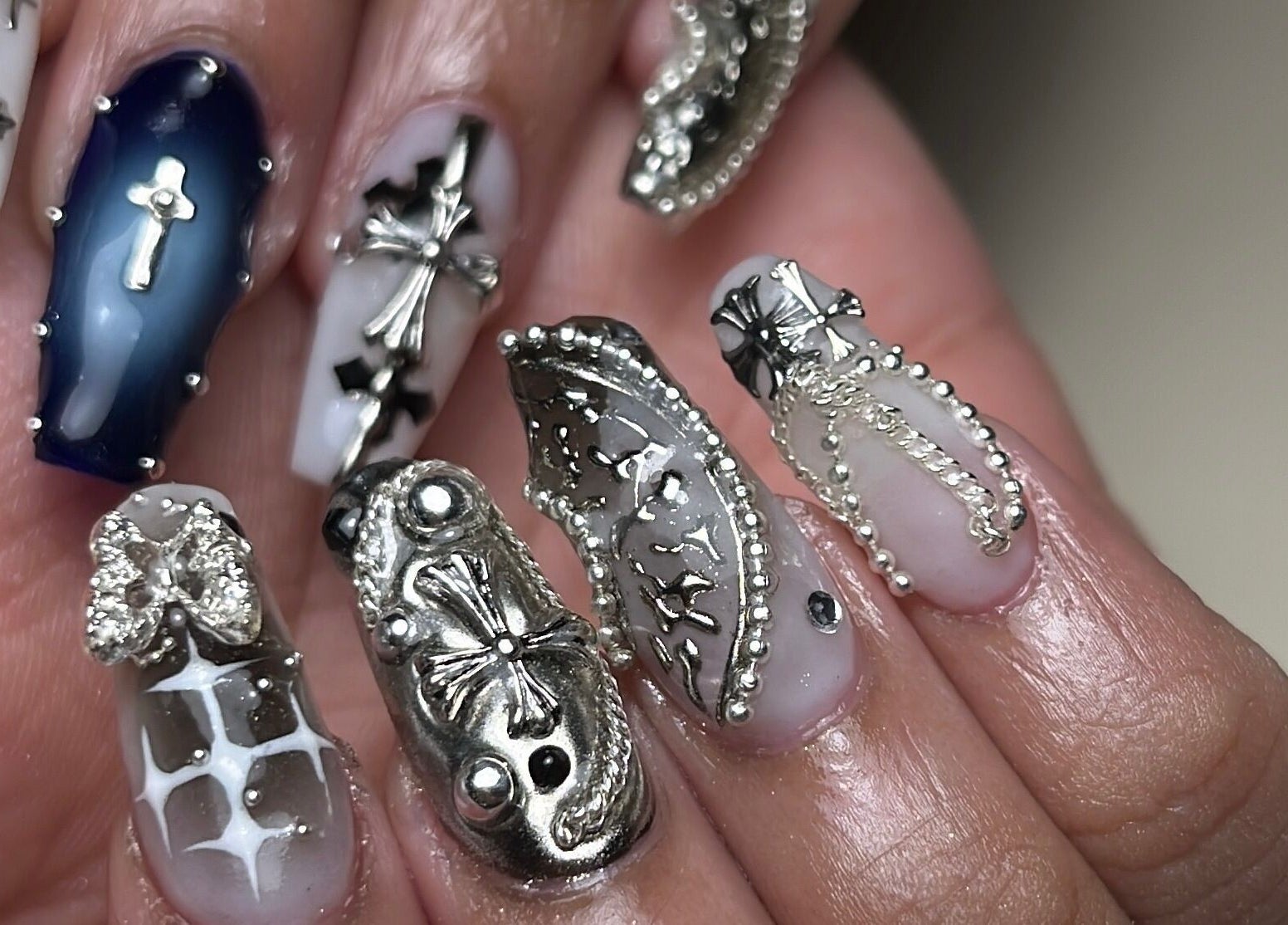 Intricate silver nail art by Aeonian Nails in Petaling Jaya, Selangor, MY showcases creative designs.