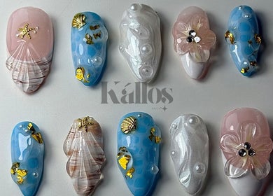 Intricate nautical-themed nail art by Kallos Nails, Racine, Wisconsin, US, showcasing sea shell and pearl designs.