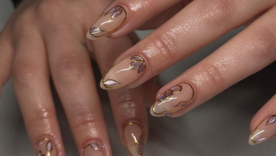 Intricate nail art with gold and purple design at Kállos Nails, Fort Lauderdale, Florida, US.