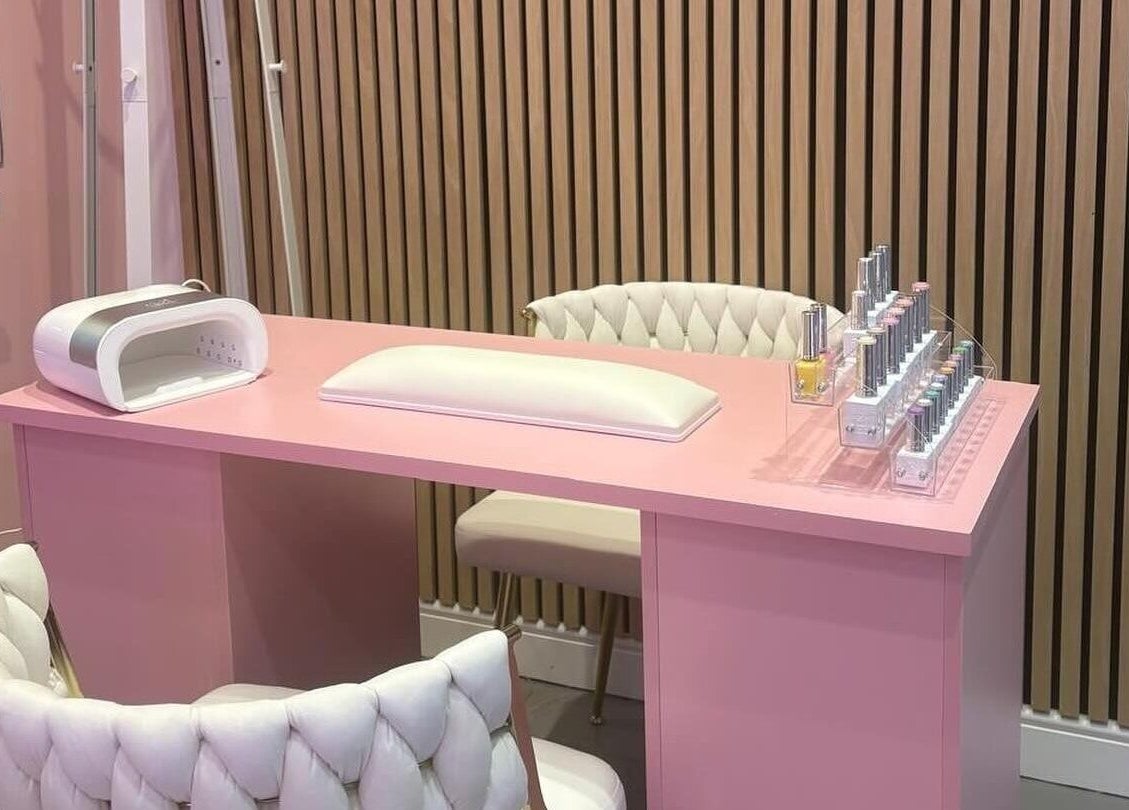 Elegant pink nail station at byzayleigh in Hinckley, England, GB featuring plush chairs and nail polish display.