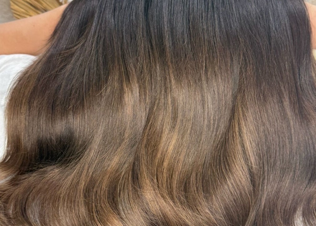 Glossy brown hair with highlights styled at byzayleigh, Hinckley, England, GB.